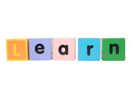 assorted childrens toy letter building blocks against a white background that spell learn with clipping path
