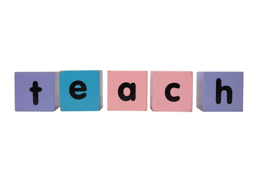 assorted childrens toy letter building blocks against a cloud background that spell teach with clipping path