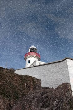 lighthouse during a rain storm on the rocks in youghal county cork ireland