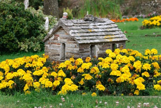 model of a stone house in a garden in Tintagel in Cornwall