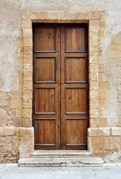 Vintage brown wooden door in Italy