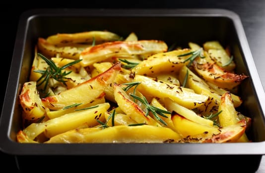 Baked potatoes with rosemary in casserole