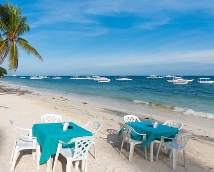 dining tables on a tropical beach
