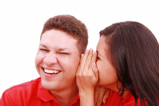 woman telling a man a secret - surprise and fun faces - over a white background