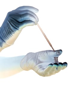 Shaded hands in gloves hold pipette and tube