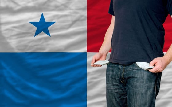 poor man showing empty pockets in front of panama flag