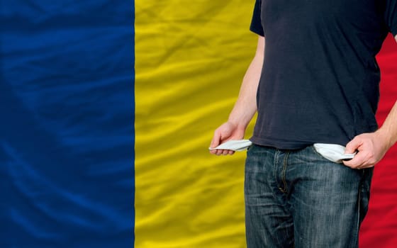 poor man showing empty pockets in front of romania flag
