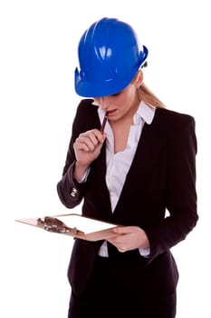 A successful businesswoman standing and wearing a blue safety hardhat.