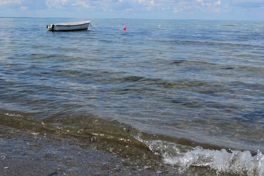 Moored boat floats lonely in the sea
