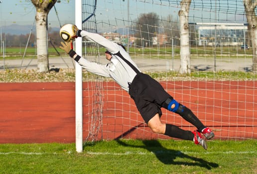 Soccer football goalkeeper making diving save