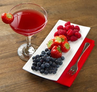 fruit juice with berries on wooden background
