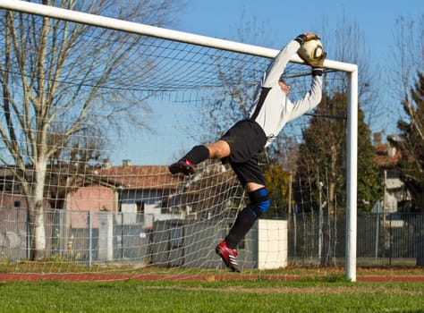 Soccer football goalkeeper making diving save