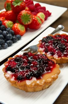 cake with berries on wooden background