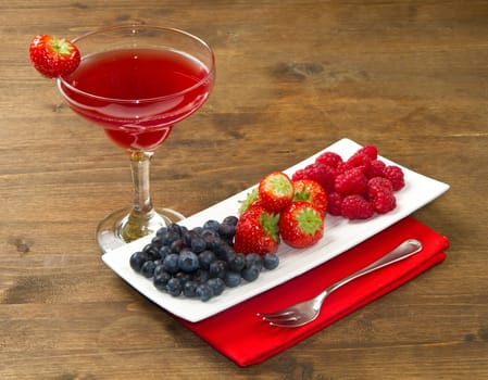 fruit juice with berries on wooden background