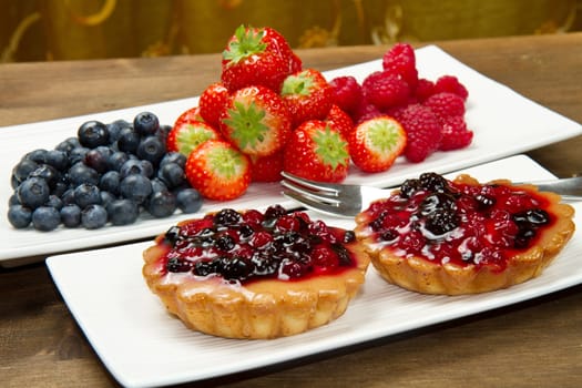 cake with berries on wooden background
