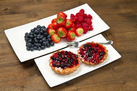 cake with berries on wooden background