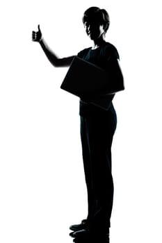 one caucasian young teenager silhouette boy  girl holding carrying laptop computer thumb up full length in studio cut out isolated on white background