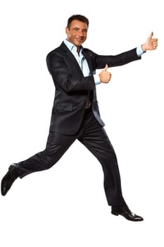 one caucasian business man running jumping double thumbs up in studio isolated on white background
