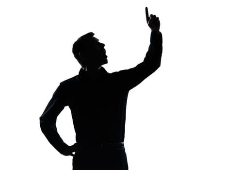 one caucasian business man pointing up surprised  portrait silhouette in studio isolated on white background