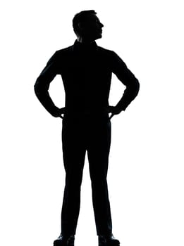 one caucasian business man silhouette standing hands on hips Full length in studio isolated on white background