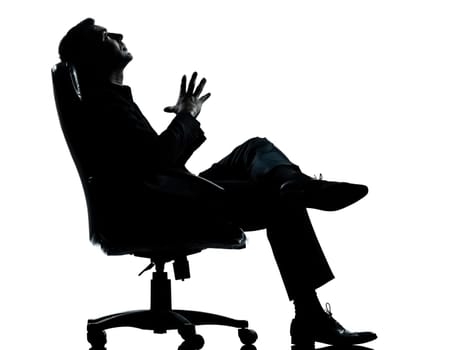 one caucasian business man relaxing thinking sitting in armchair silhouette Full length in studio isolated on white background
