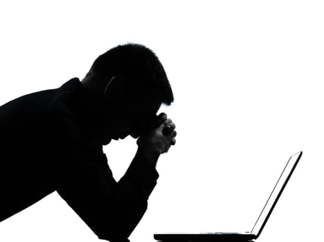 one caucasian business man computing computer laptop despair sad portrait silhouette in studio isolated on white background