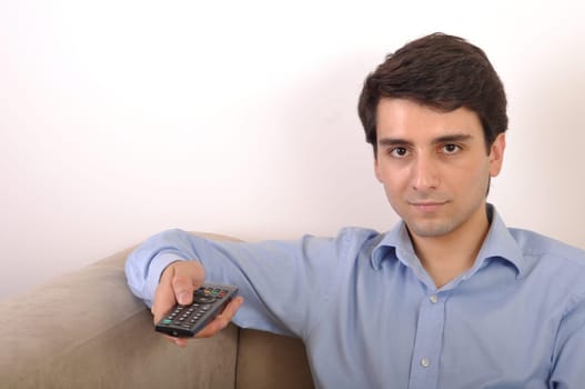 smiling attractive young man watching televison