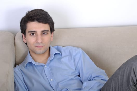 attractive young man lying and relaxing on the couch