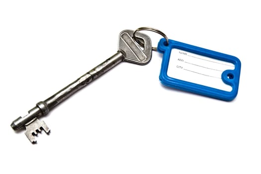 Old key with tag isolated on white background