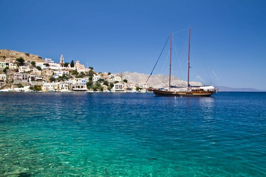 Colorful houses and sailing boat in Symi  island of Greece