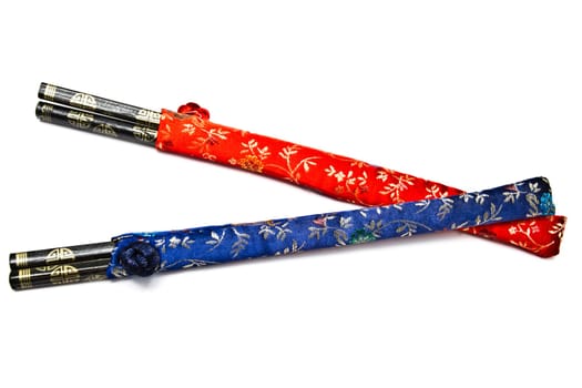 Two set of chopsticks closeup on white background