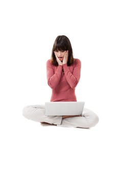 Beautiful woman surprised, with a laptop in studio with white background