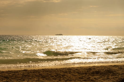 passenger ship at the horizon against a beautiful sunset