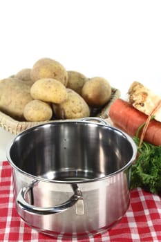 Pot and fresh ingredients for a potato soup