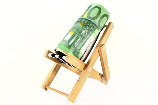 A deckchair with euro notes against a white background