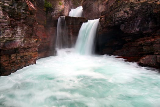 Rushing waters of Saint Mary Falls at Glacier National Park - USA.