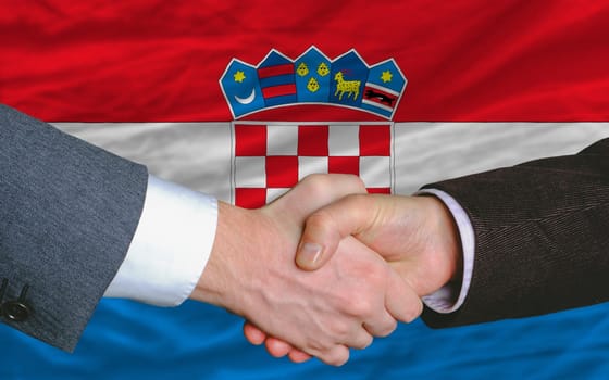 businessmen handshakeafter good deal in front of croatia flag