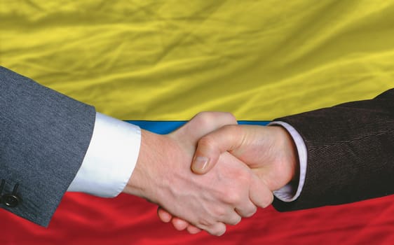 businessmen handshakeafter good deal in front of columbia flag