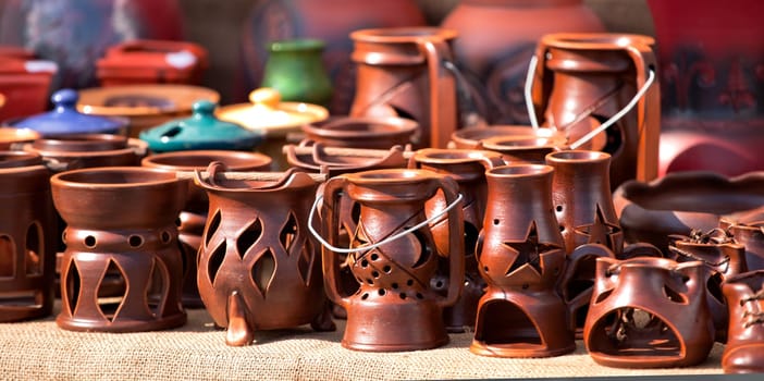 Panoramic view of various pottery souvenirs at a folk fair in Romania.