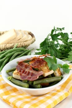 a plate of green beans and fried bacon