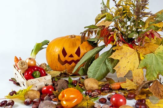 halloween pumpkin with autumn leaves on a white background