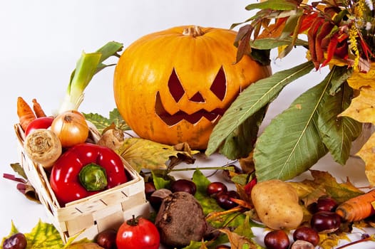 halloween pumpkin with autumn leaves on a white background