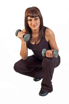young woman lifting weights on white background