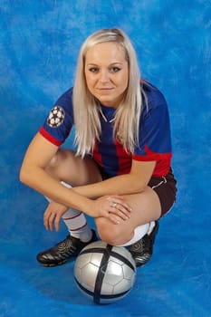 young girl with the football on the blue mosaic background