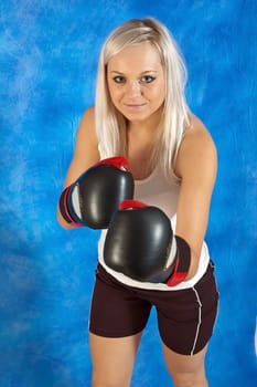 young sexy girls in boxing gloves on the blue mosaic background