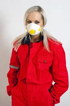 young woman builder in white helmet holding driller