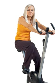 young woman riding a fitness bicycle isolated against a white background.