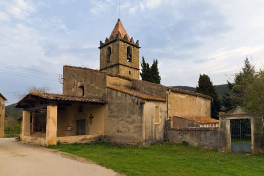 Cogolls, Barcelona. Typical Catalan countryside, rural grass, the church, surrounded by mountains.