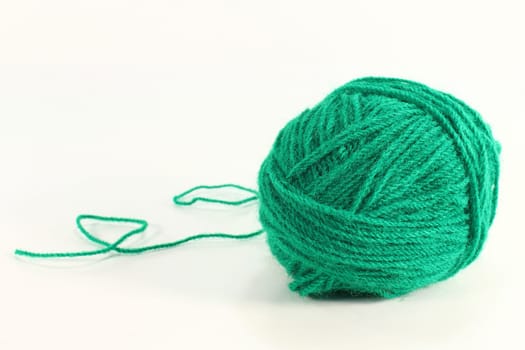 a green ball of wool against a white background