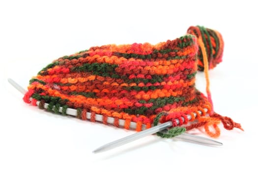 a colourful ball of wool with a knitting sample